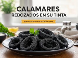 Calamares rebozados con tinta de calamar servidos en plato blanco sobre mesa de madera con alioli y limón, receta fácil y crujiente