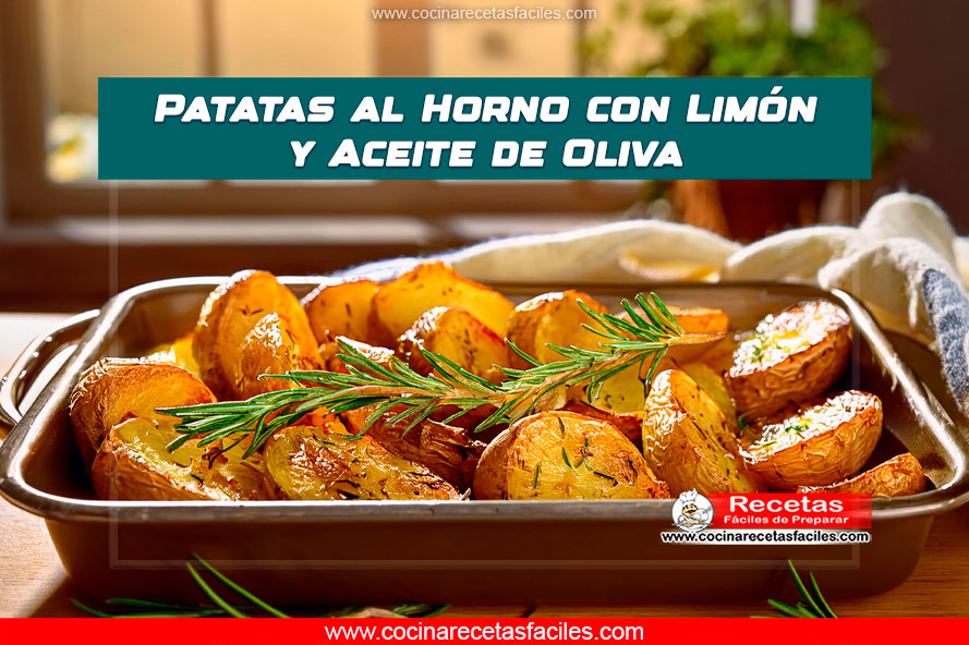 Patatas al horno con limón y aceite de oliva dispuestas en una bandeja con hierbas frescas