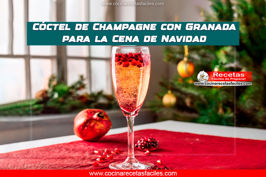 Cóctel de champagne con granada servido en copa elegante, decorado con granos de granada, rodaja de limón y menta fresca