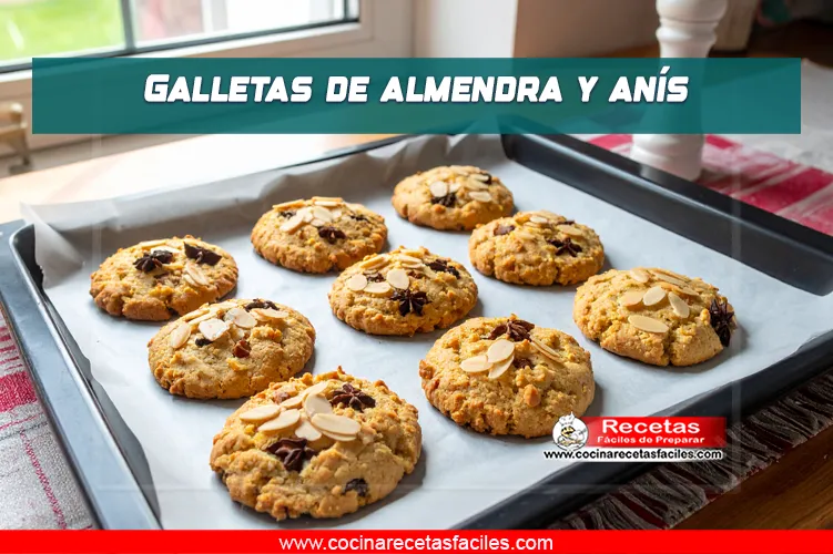 Galletas caseras de almendra y anís decoradas con almendras laminadas, recién horneadas sobre bandeja con papel pergamino