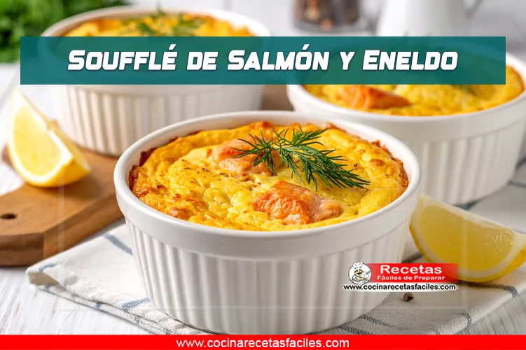 Soufflé de salmón servido en ramekin, decorado con eneldo fresco, con textura dorada y cremosa. Presentado con limón y eneldo fresco al lado
