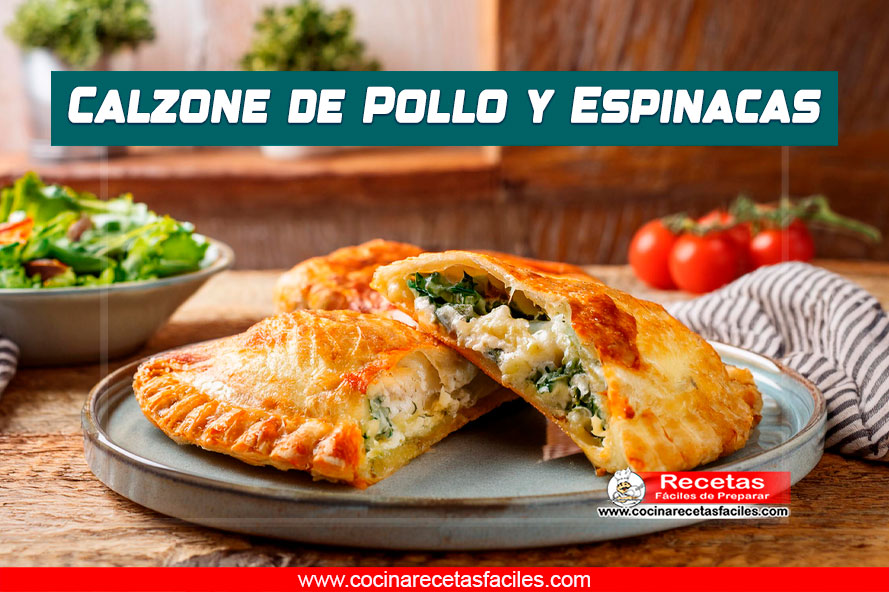 Calzone dorado relleno de pollo, espinacas y queso, con bordes trenzados.