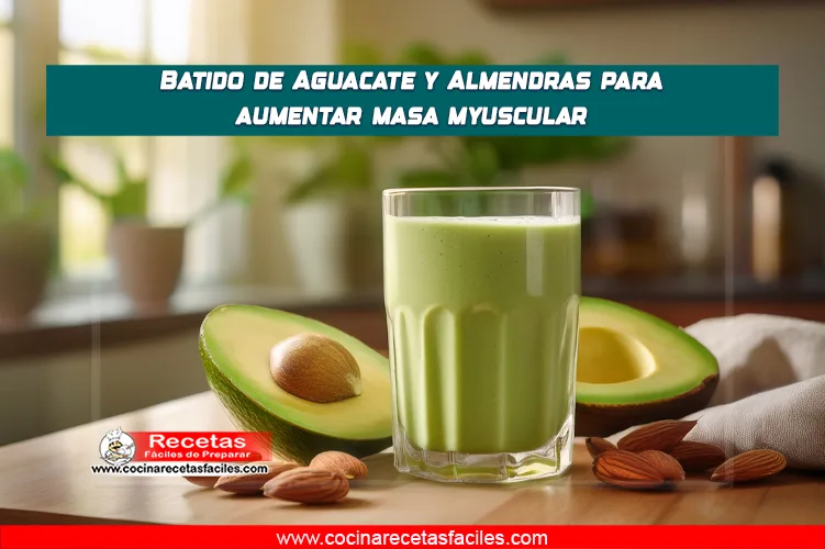 Batido verde de aguacate y almendras en un vaso, decorado con almendras fileteadas y una rodaja de aguacate.