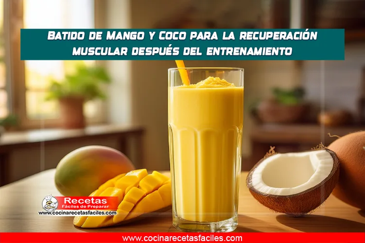 Batido amarillo de mango y coco en un vaso, decorado con coco rallado y un trozo de mango.