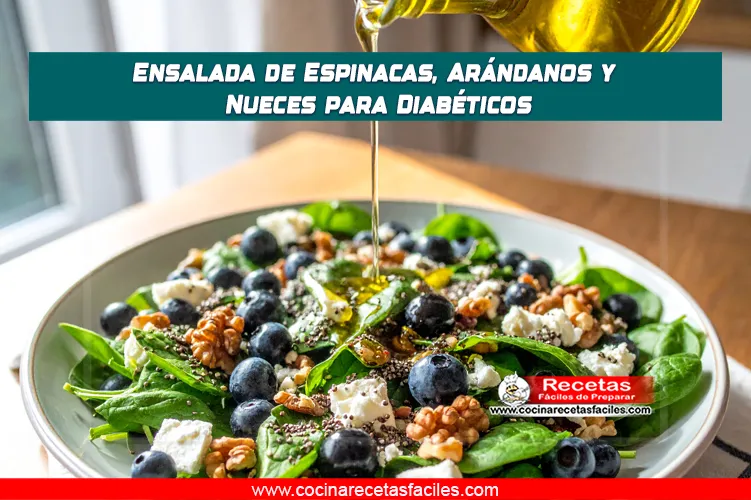 Ensalada de espinacas con arándanos, nueces y queso feta en un tazón sobre mesa de madera.