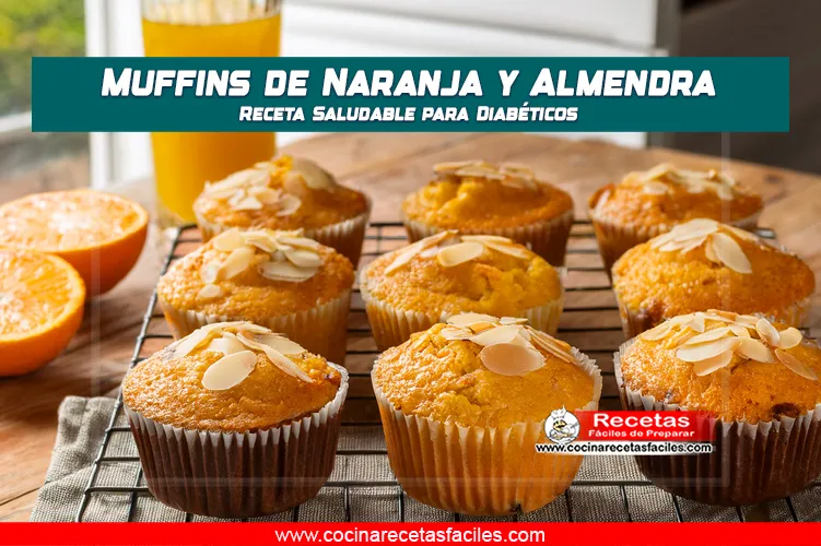 Muffins dorados de naranja y almendra sobre rejilla con naranja fresca y jugo natural al lado